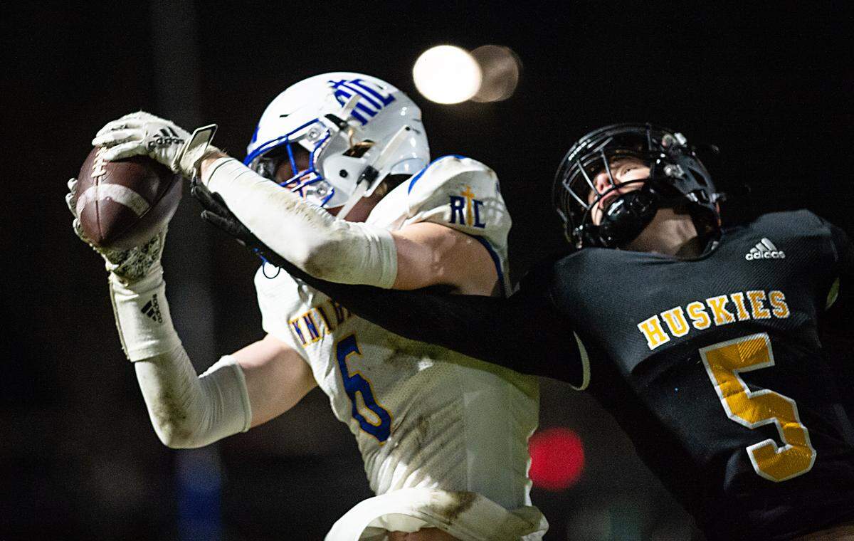 Ripon Christian’s Eli Terpsma makes a touchdown catch over Hughson’s Larkin Meyer during the CIF Division 5-AA Northern California Regional Bowl Game on Friday, Dec. 2, 2022, in Hughson, Calif.