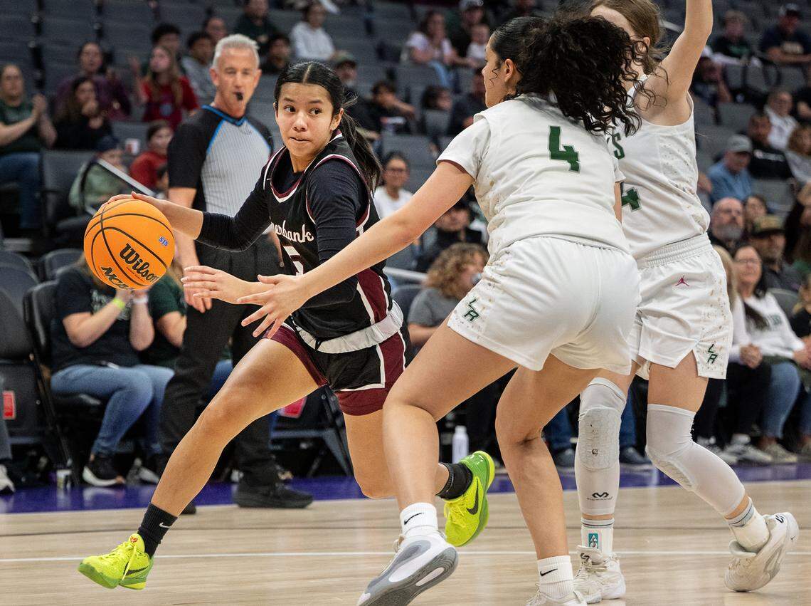 Riverbank’s Leilani Olanolan drives to the basket on Liberty Ranch’s Ella Garcia (4) during the Sac-Joaquin Section D-4 championship game at the Golden 1 Center in Sacramento, Thursday, February, 27, 2025.