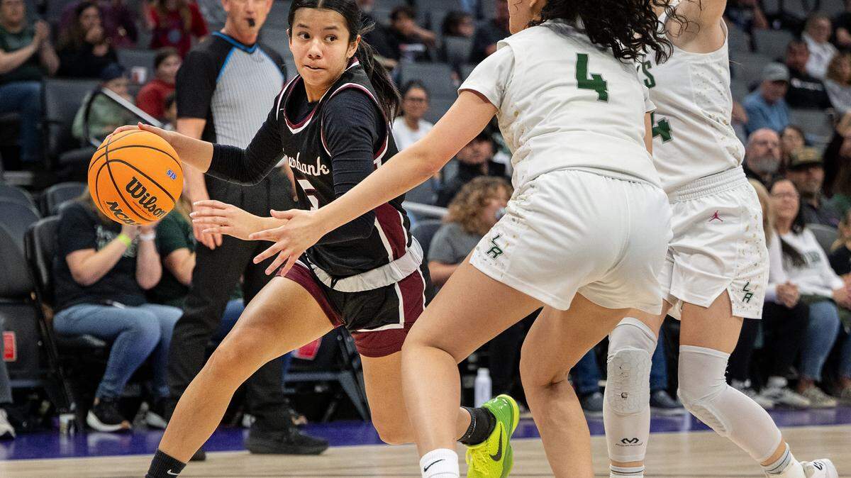 Riverbank’s Leilani Olanolan drives to the basket on Liberty Ranch’s Ella Garcia (4) during the Sac-Joaquin Section D-4 championship game at the Golden 1 Center in Sacramento, Thursday, February, 27, 2025.