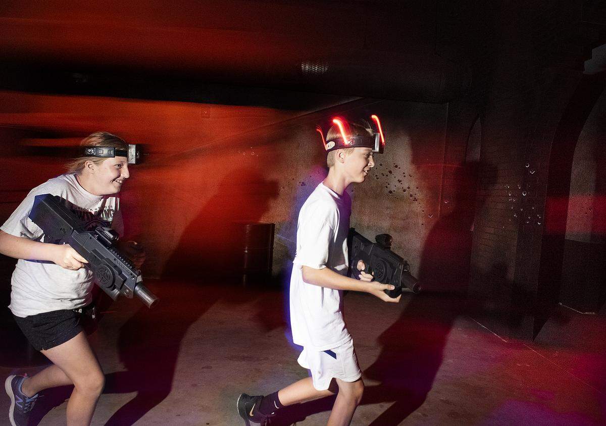 Brian Tognazzini, 10, right, and Kaitlyn, 12, play a game in the new laser tag arena at Ten Pin Fun Center in Turlock, Calif., Thursday, July 25, 2019.