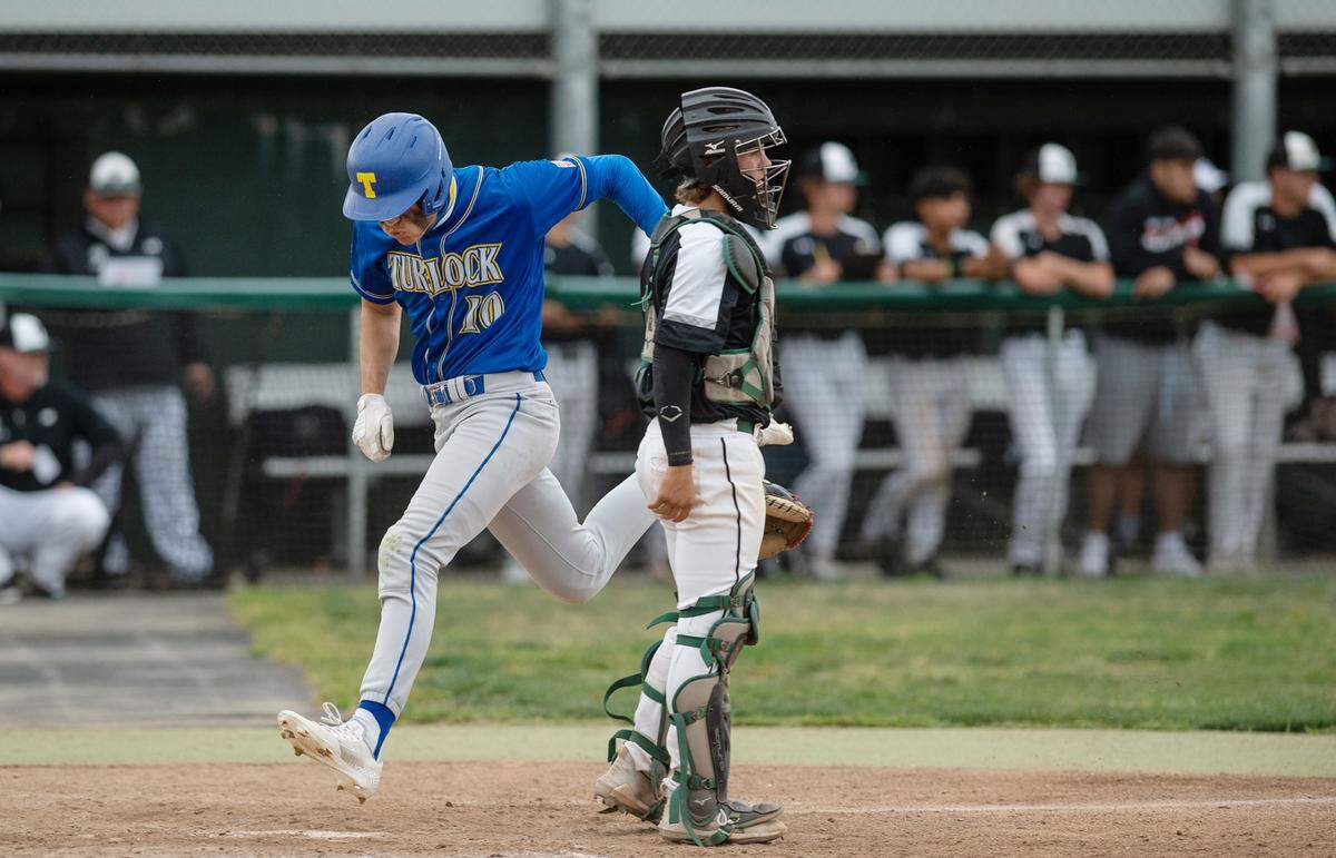 Turlock’s Logan Hart scores in the seventh inning in the Central California Athletic League game with Pitman at Pitman High School in Turlock, Calif., on Thursday, April 14, 2022.
