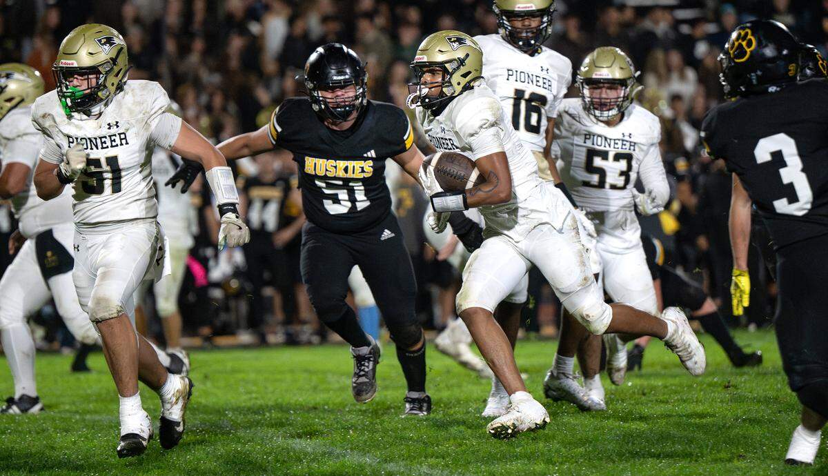 Pioneer’s Devion Corley rushes for a touchdown in the first half of the Sac-Joaquin Section Division IV quarterfinal game against Hughson on Friday.