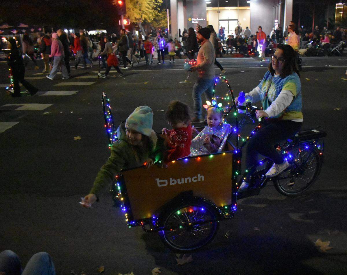 The view is great, but another perk of sitting streetside at the Celebration of Lights Holiday Parade in downtown Modesto is being closest to the loads of sweets handed out.