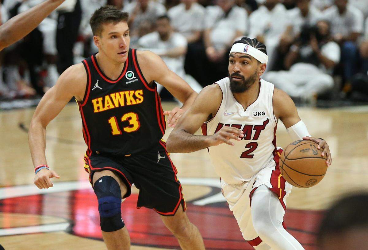 Miami Heat guard Gabe Vincent (2) drives to the basket as Atlanta Hawks guard Bogdan Bogdanovic (13) defends in the fourth quarter at the FTX Arena in Miami, Florida on Sunday, April 17, 2022.