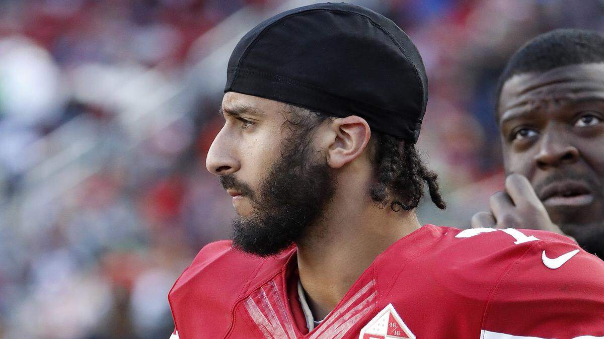 FILE - In this Jan. 1, 2017 file photo San Francisco 49ers quarterback Colin Kaepernick stands on the sideline during an NFL football game in Santa Clara, Calif.