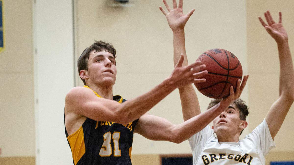 Gregori’s Eli Kirkpatrick (15) draws a charge as Turlock’s Luke LeVake attempts a shot during the Central California Athletic League game at Gregori High School in Salida, Calif., on Friday, May 14, 2021.