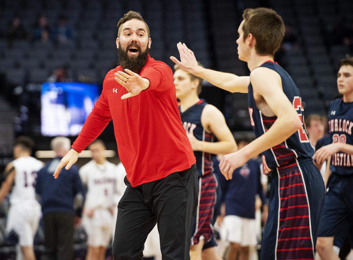 Turlock Christian coach Travis Thompson greets his players during a timeout during the Sac-Joaquin Section Division VI boys basketball championship game with Vacaville Christian at the Golden1 Center in Sacramento, Calif., Friday, Feb. 22, 2019.