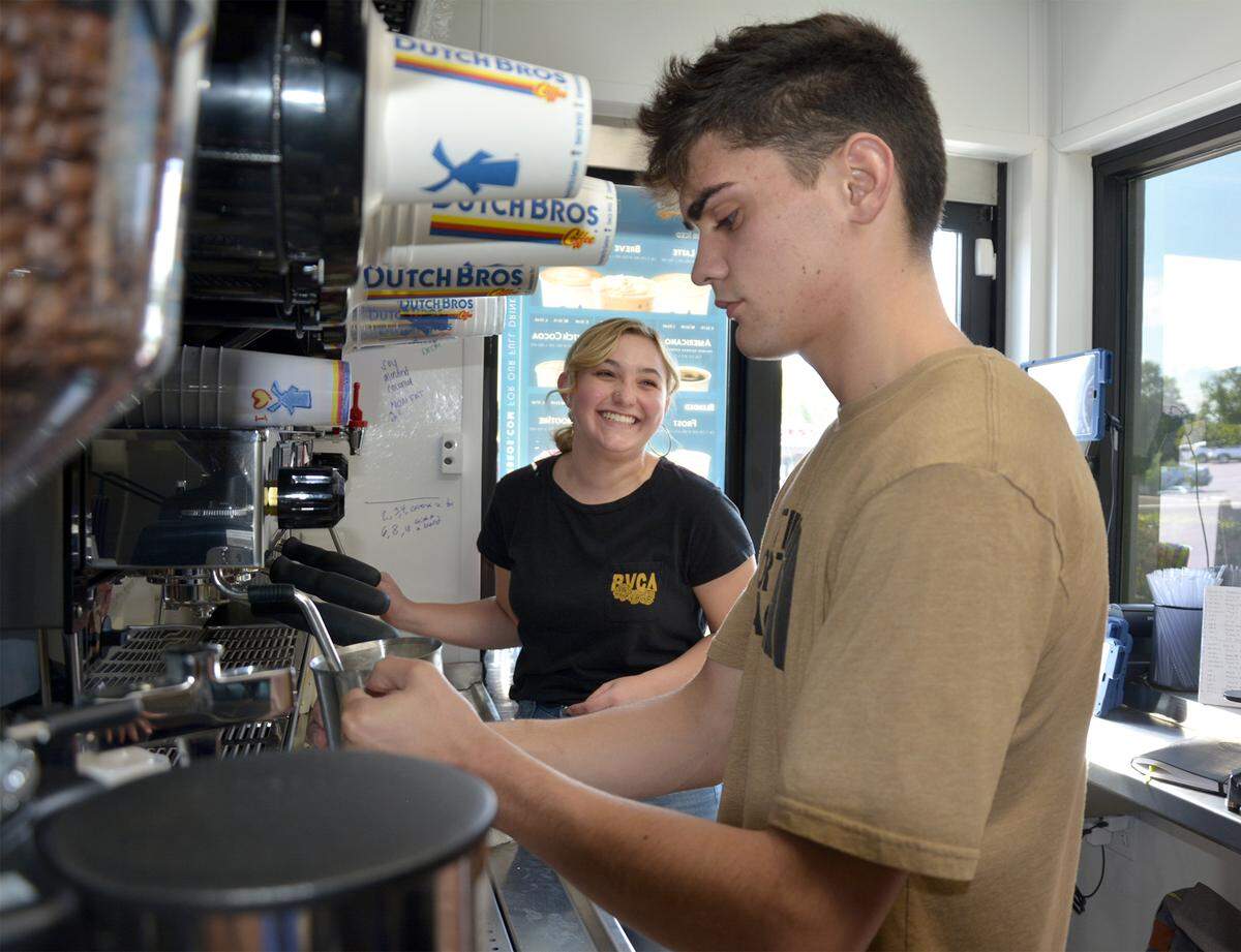 Dutch Bros Coffee employees Kelii Carr (front) and Madison Dampier are trained inside the drive-up coffee chain’s new location in Oakdale, Calif., which opens Friday, Aug. 30, 2019.