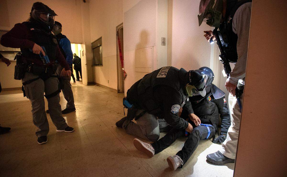 A Modesto Police officer tends to an “injured” shooting victim as officers train during an active shooter scenario in Modesto, Calif., Wednesday, Feb. 15, 2023.