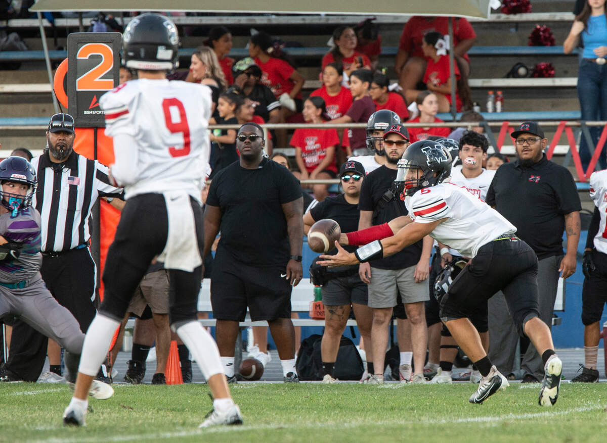 Garrett Bidwell, 5, grabs a pass from Eli McCabe, 9, for a gain against Johansen High Friday August 19, 2022.