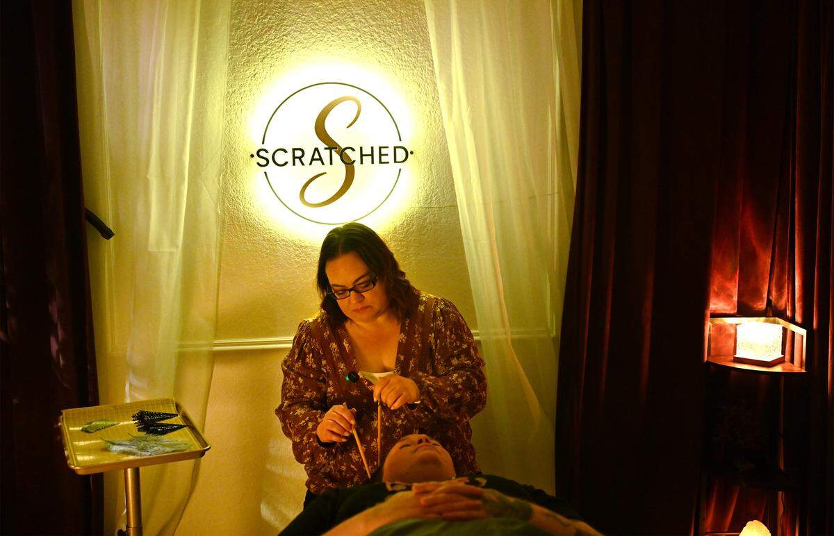 Scratched studio owner Sarah Kalinoff demonstrates ASMR-style soft touch therapy using chopsticks.