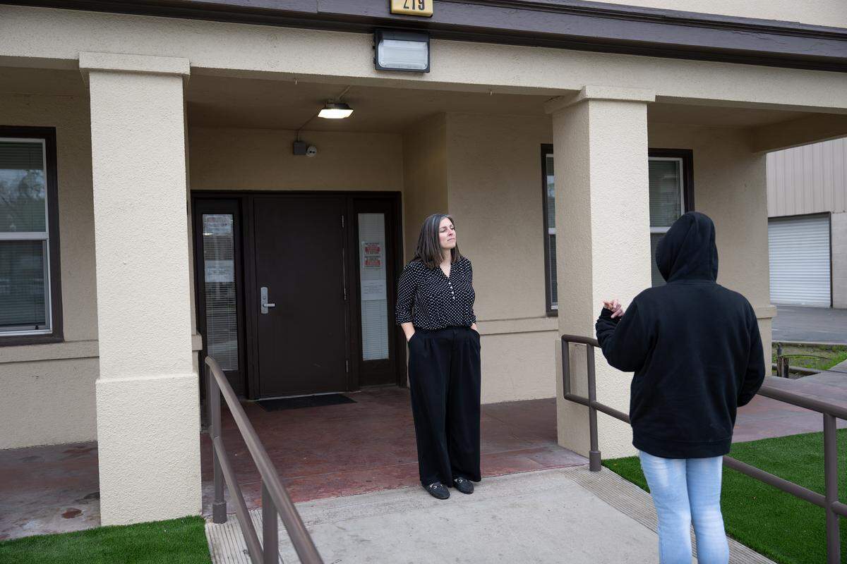 We Care shelter director Corey Mai talks with a person outside the building in Turlock, Tuesday, Dec. 30, 2025. The shelter serves about 49 men each night.