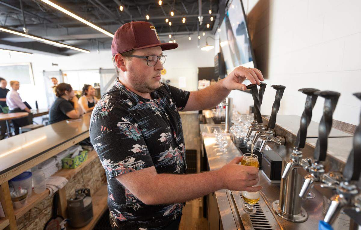 Andrew Sciabica pours a flight of beer at the Track 424 Brewery taproom in Modesto, Calif., Friday, June 28, 2024.