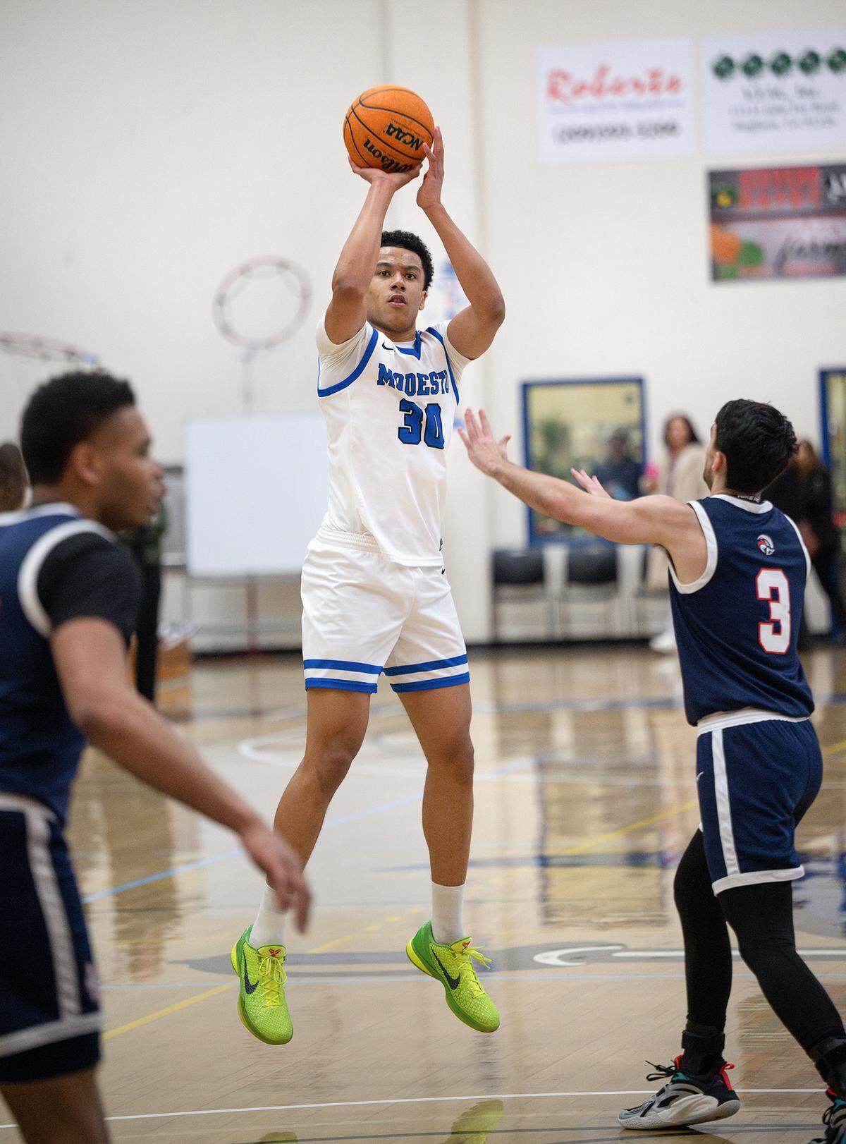 Modesto’s Ylan Esso shoots a three point basket during the Big 8 Conference game with American River College at Modesto Junior College in Modesto, Thursday, Feb. 13, 2025. Modesto won the game 115-78.