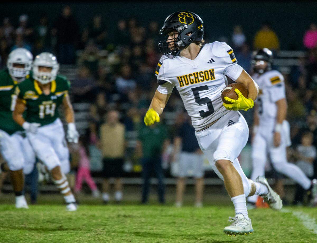 Larkin Meyer, 5, of Hughson High works his way up field with Hilmar Highs defense closing in during the first half of Friday Oct. 20, 2023 nights game at Hilmar.