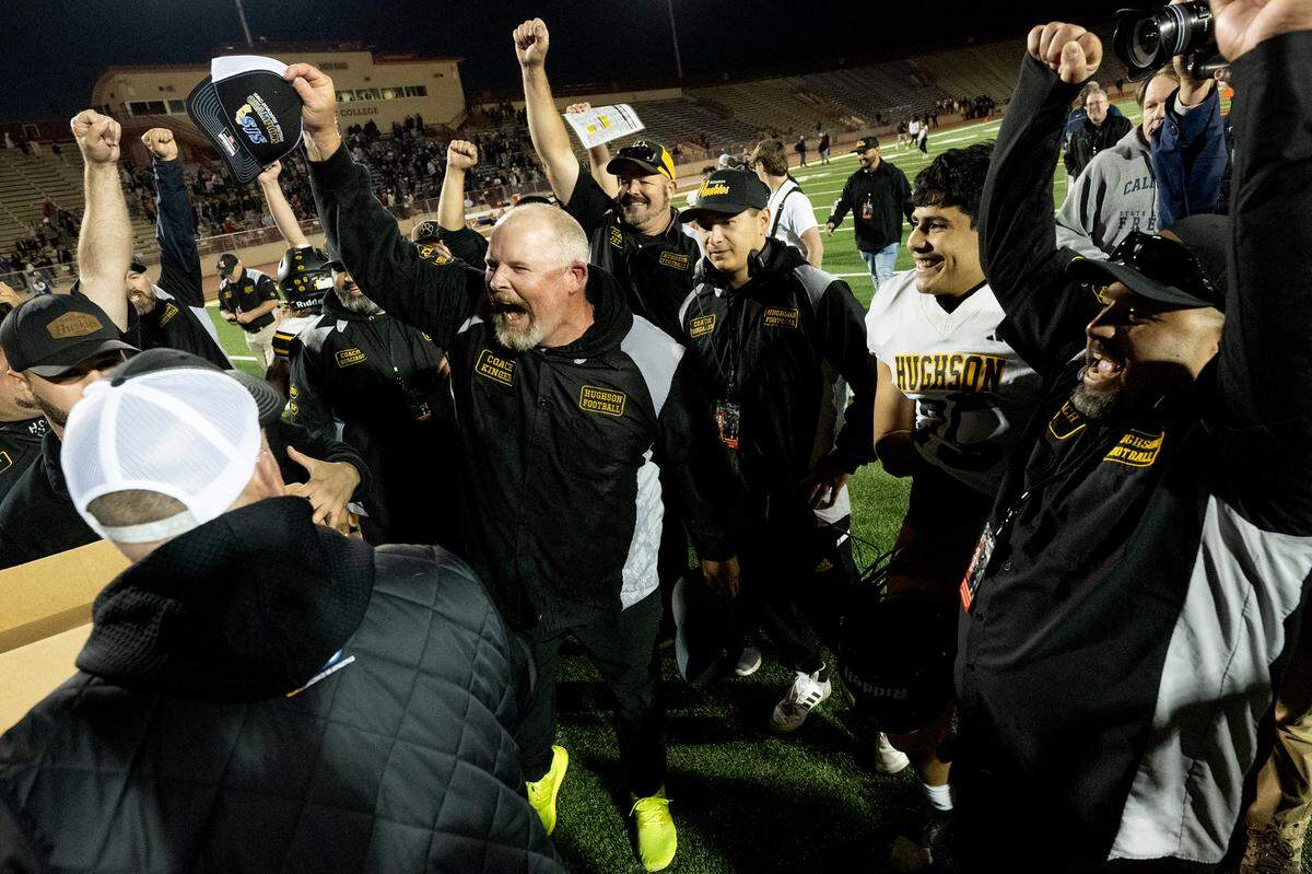 Hughson coach Shaun King, left, celebrates their 40-39 victory over Bradshaw Christian in the Sac-Joaquin Section Division VI championship game at Sacramento City College in Sacramento, Calif., Saturday, Nov. 25, 2023.