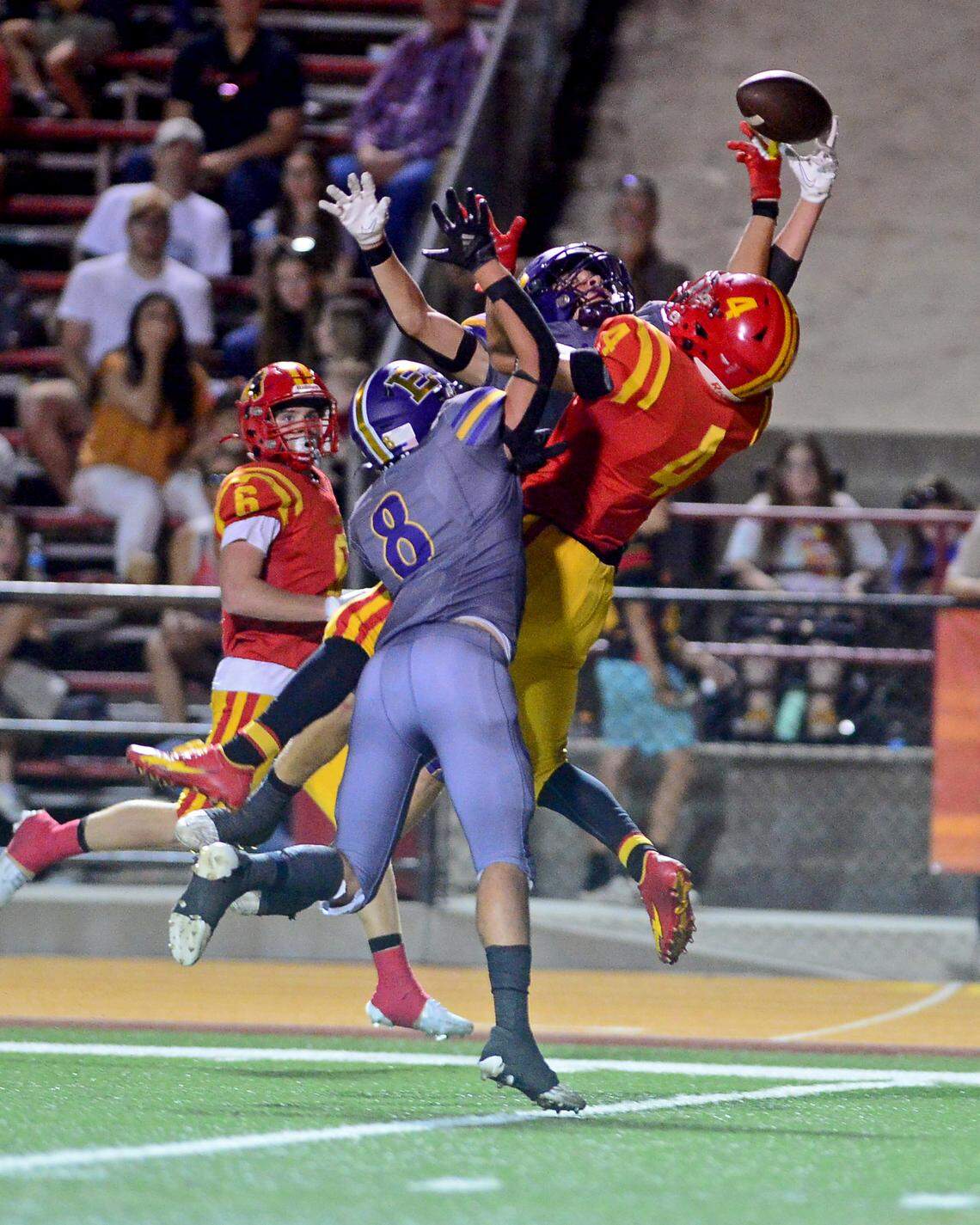 Oakdale receiver Joseph Delte (4) leaps to try to make a catch over multiple Escalon defenders during a game between Oakdale and Escalon at Oakdale High School in Oakdale, California, on September 15, 2023.