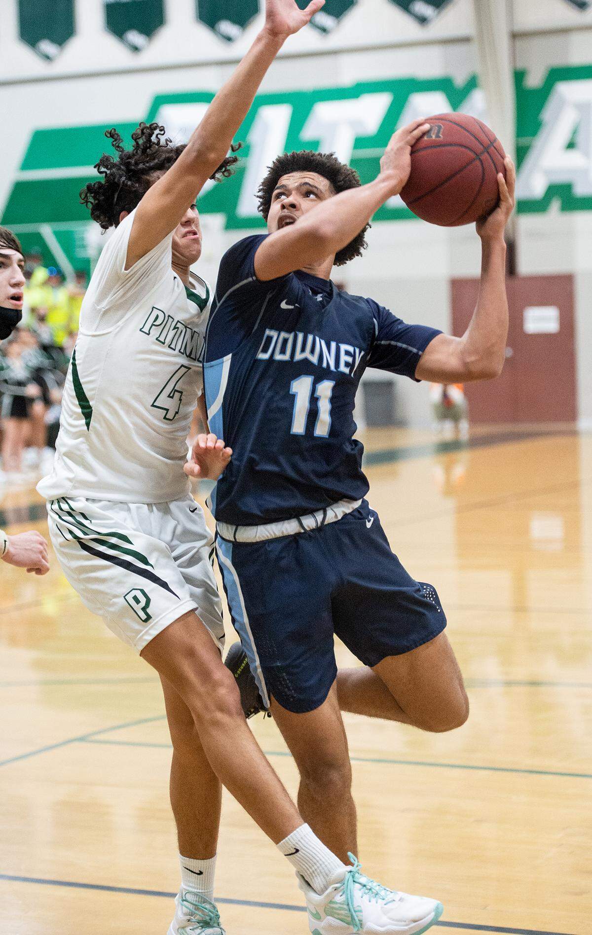 Downey’s Lloyd French scores past Pitman defender Justin Anderson during the Central California Athletic League game at Pitman High School in Turlock, Calif., on Friday, Feb. 4, 2022. Downey won the game 56-52.