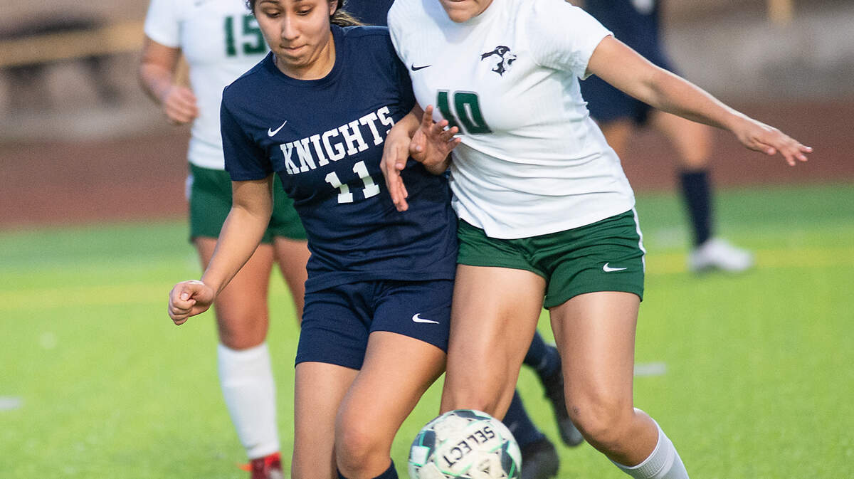 Pitman’s Lillyana Rodriguez (10) and Downey’s Yajaira Romero-Zamorano battle for the ball during the Central California Athletic League game at Downey High in Modesto, Calif., on Tuesday, Jan. 4, 2022. Pitman won the game 6-0.