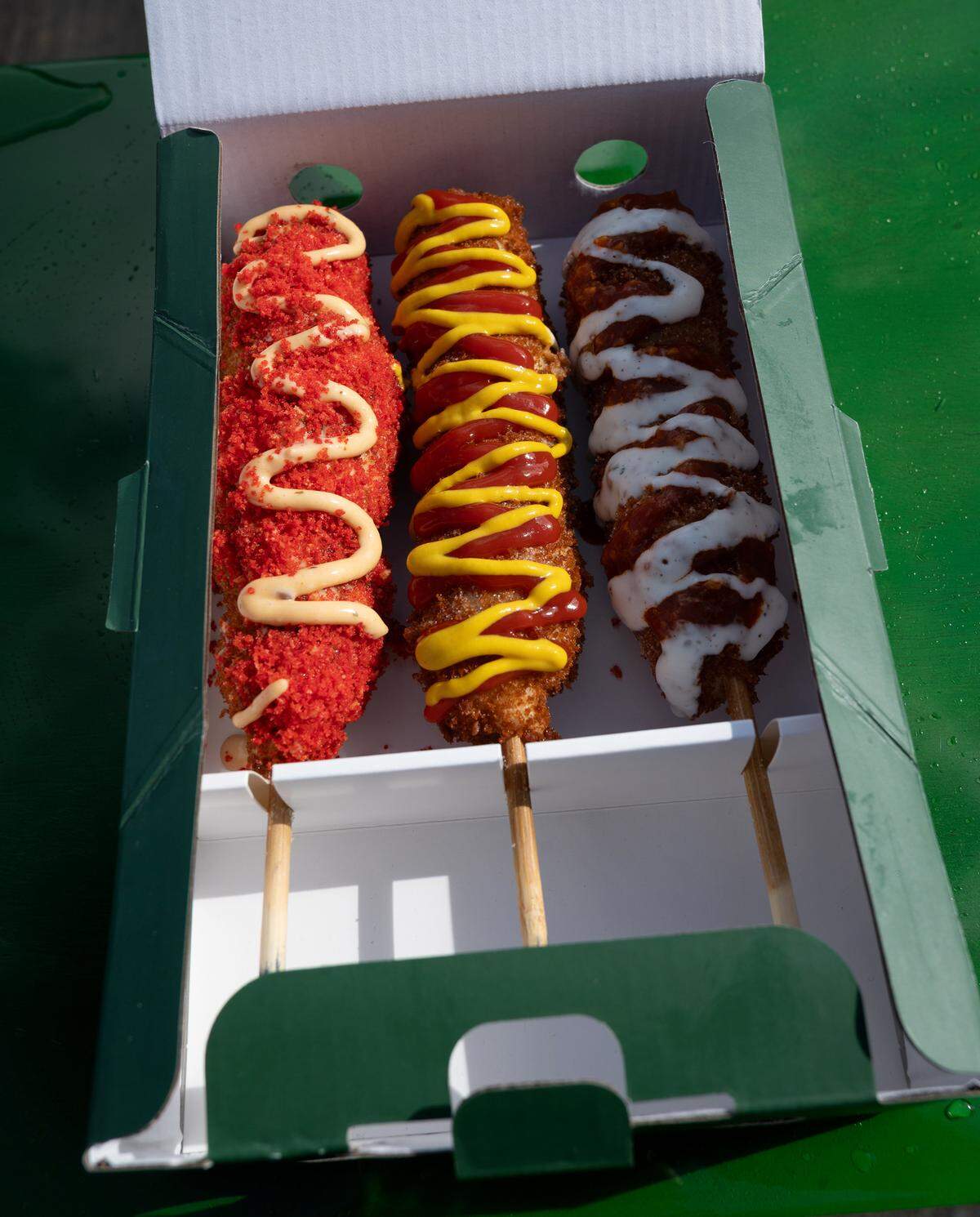 From the left, Cheeetos, Retro American and Umami dogs at Corn’d Korean corn dogs in Turlock, Calif., Thursday, Feb. 15, 2024.