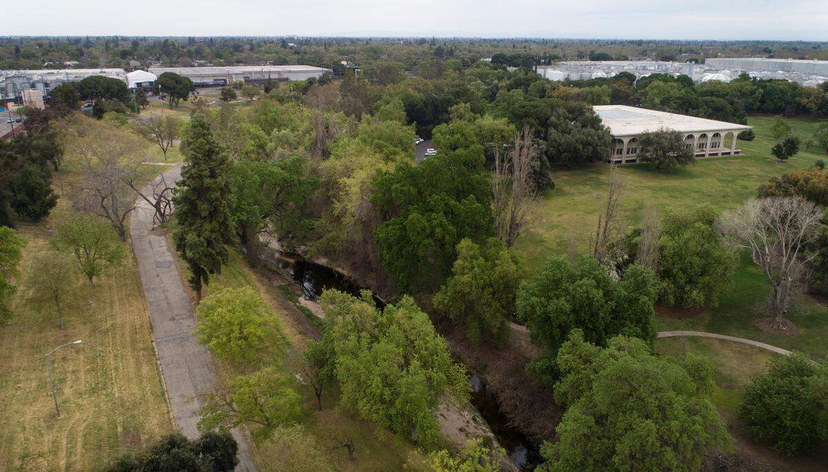 Beard Brook Park with Gallo Winery on the east side of Dry Creek in Modesto, Calif., on Thursday, March 17, 2022. The city of Modesto is working on a land swap with Gallo Winery. The city would trade the 12-acre Beard Brook Park for a 12-acre, half-mile strip of open land Gallo owns along the Tuolumne River between Dry Creek and Santa Cruz Avenue.