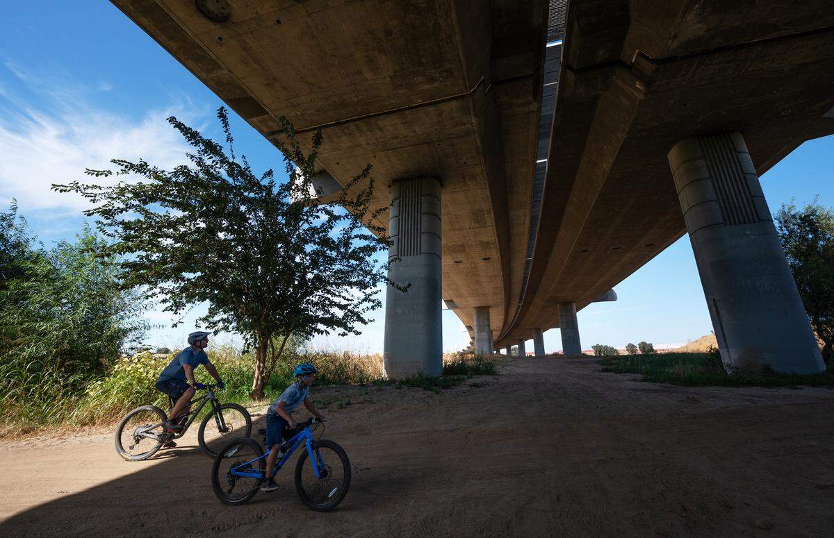 Bikers pass under the 9th Street Bridge during Modesto RecFest at Gateway Park in Modesto, Calif., Saturday, Oct. 21, 2023.
