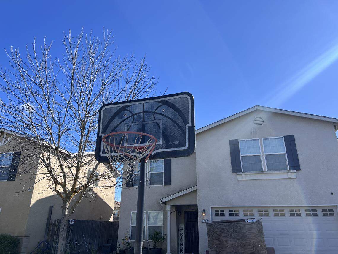 A basketball hoop left on street in Merced, California.