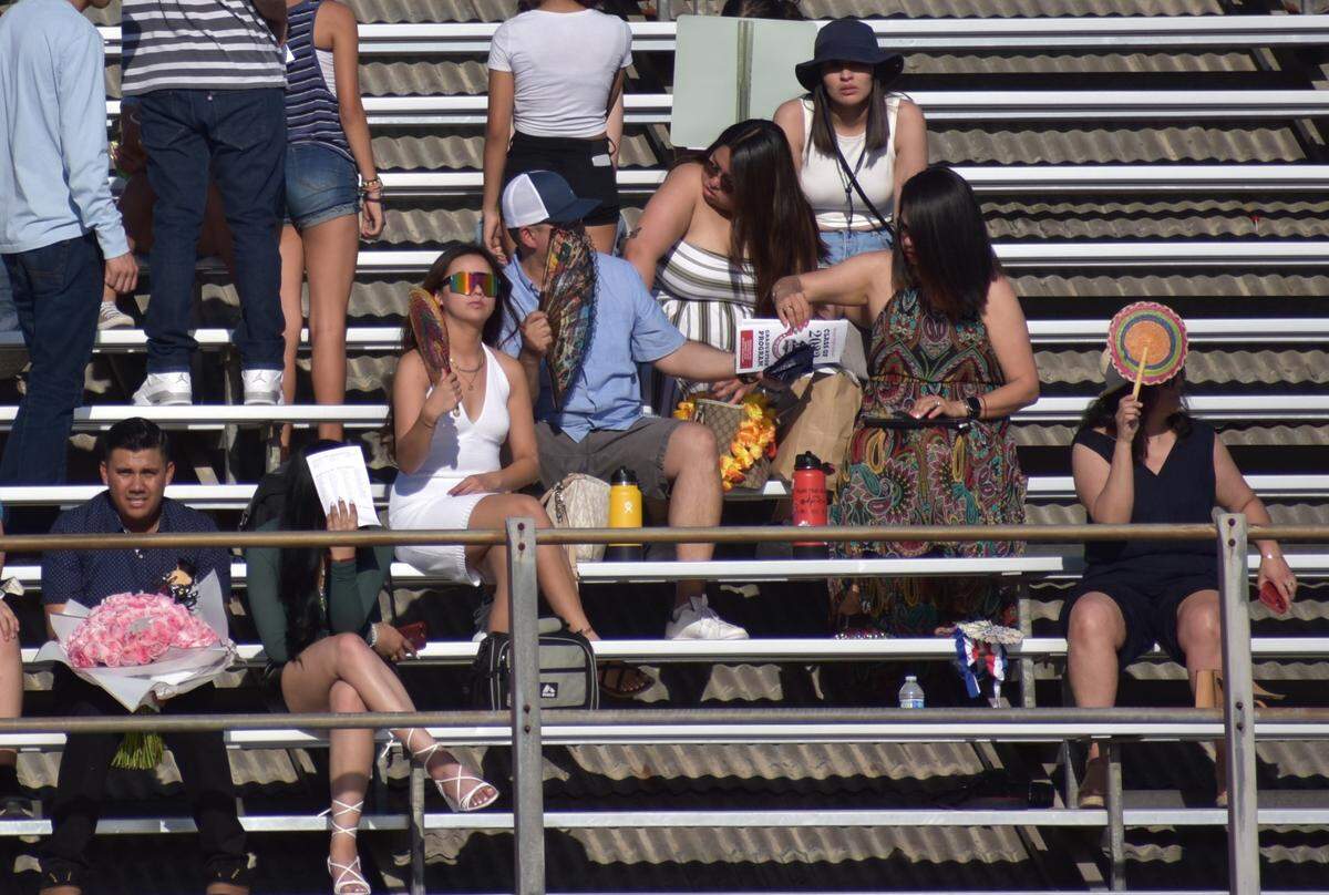 Fans, hats and hydration were among the ways audience members tried to beat the heat Wednesday afternoon and evening, May 26, 2022, at the Beyer High graduation ceremony at Modesto Junior College.