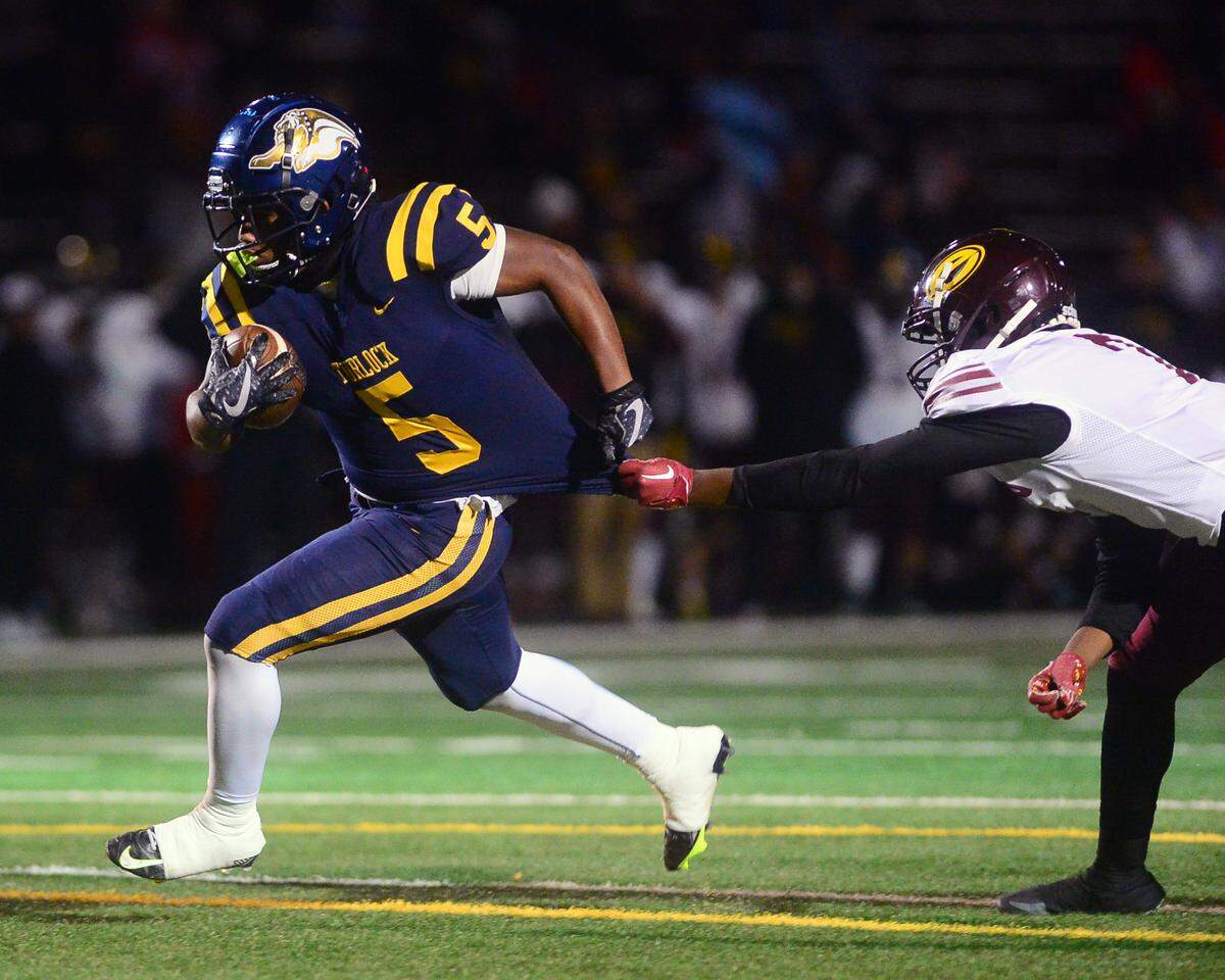 Turlock running back JT Foreman II (5) runs through an arm tackle during a CIF Division I CIF Sac-Joaquin Section Football Playoff game between Turlock High School and Edison High School at Turlock High School in Turlock CA on November 4, 2022. Turlock won 35-0.