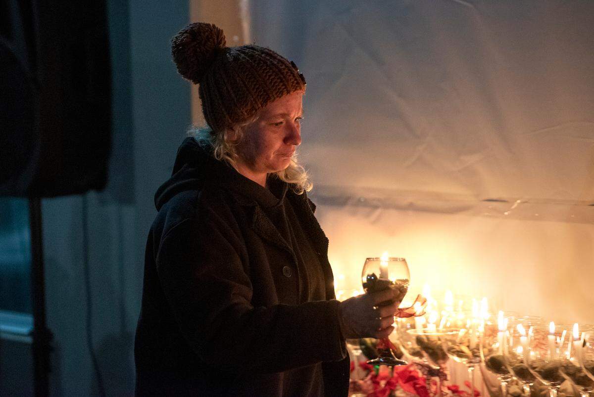 Aimee Harp places a candle to remember her boyfriend Isaiah Garcia, who died in 2020, as a small group attended a ceremony honoring people who died while experiencing homelessness in Stanislaus County. The vigil remembered those who died in both 2020 and 2021 during a ceremony at The Salvation Army Berberian Shelter in Modesto, Calif., on Tuesday, Dec. 21, 2021. The event occurred on National Homeless Persons’ Memorial Day, which marks the winter solstice and longest night of the year.