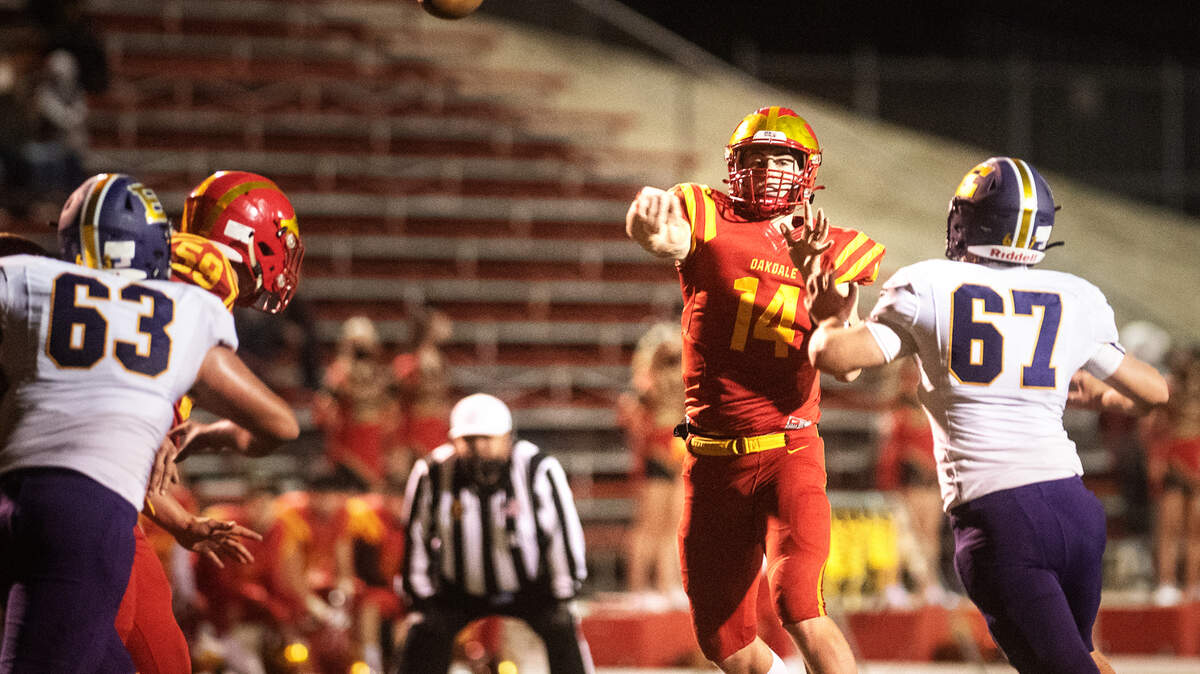 Oakdale quarterback Jackson Holt makes a pass during the Valley Oak League game with Escalon in Oakdale, Calif., on Friday, March 19, 2021.