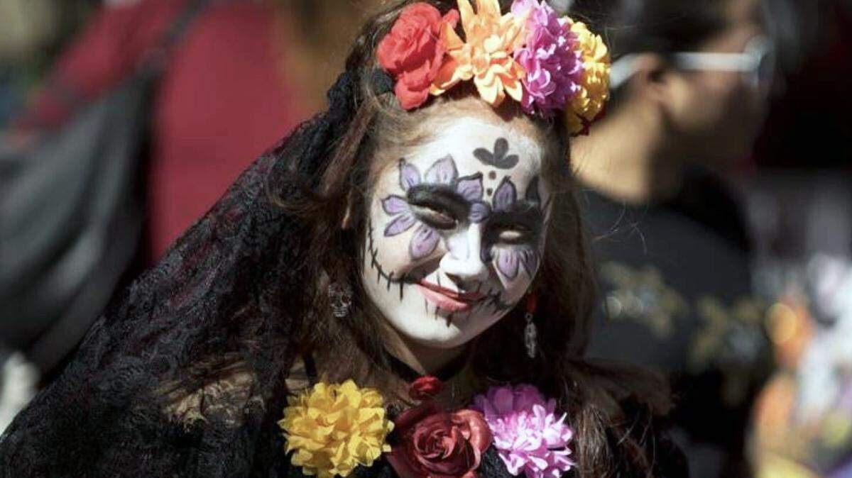 Skye Garcia, 10, of Livingston shows the face painting that her mother did for her to celebrate Dia de Los Muertos in Modesto, Calif., on Saturday, Oct. 21, 2017.