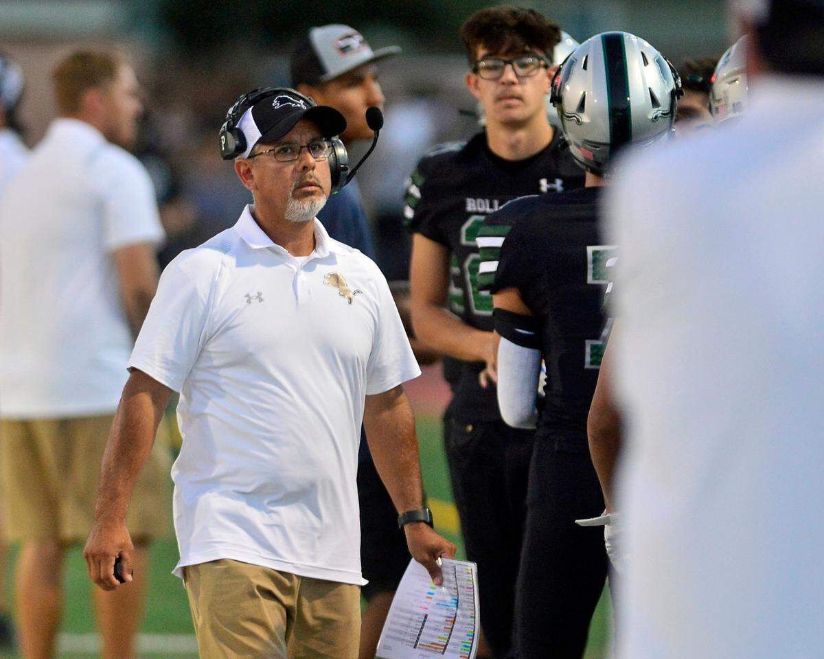 Pitman head coach Eric Reza walks the sideline during a game between Turlock High School and Pitman High School at Turlock High School in Turlock, Calif., on September 30, 2022.