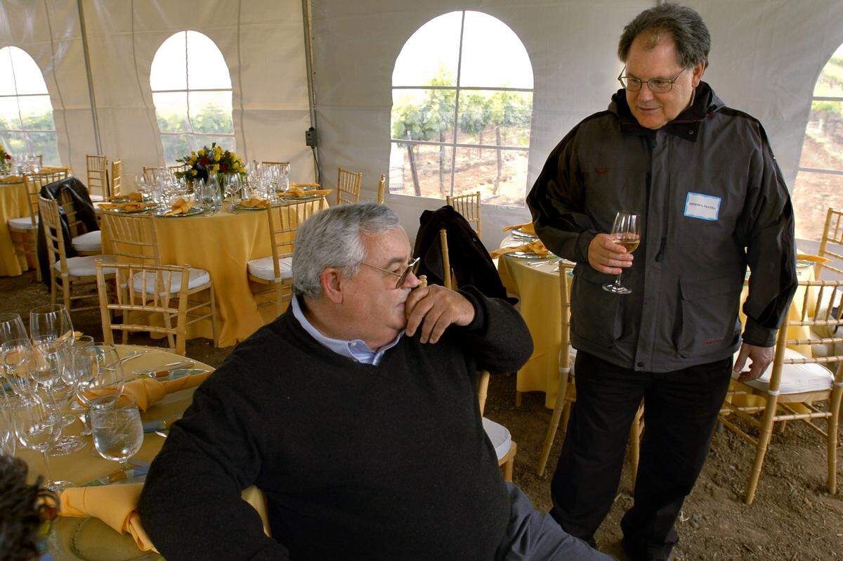 Fred Franzia, left, and his brother Joseph Franzia speak briefly before a press luncheon in their Bronco Wine Company vineyard in Herald on April 20, 2004. The Bronco Wine Company is responsible for the inexpensive }Charles Shaw” wine that became affectionately known as “Two Buck Chuck.”