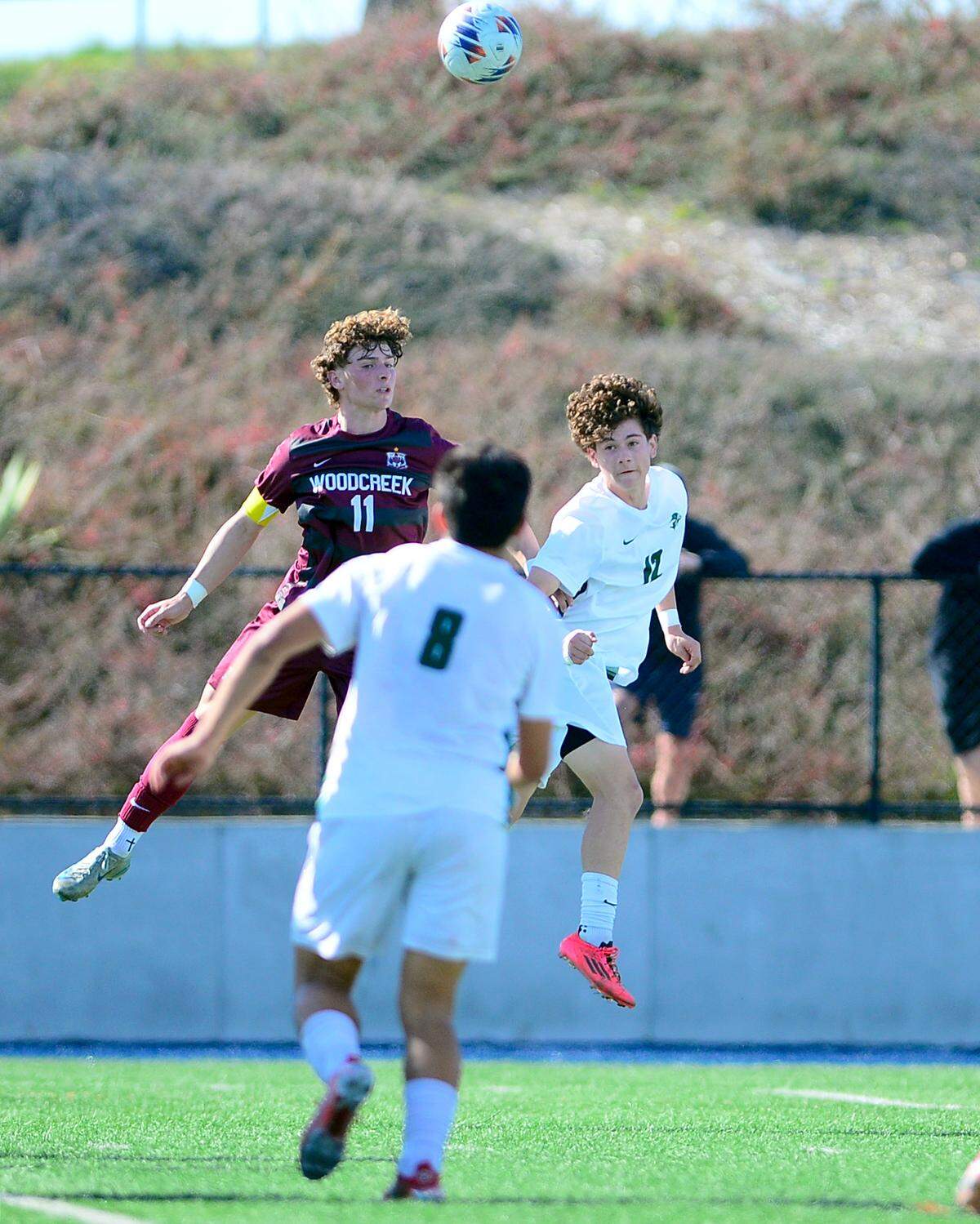 Pitman’s Keegan Pires (12) wins a header against Woodcreeks Vince Noble (11) during the Sac-Joaquin Section Division II championship against Woodcreek High School at Cosumnes River College in Sacramento, Calif. on Saturday, March 1, 2025.