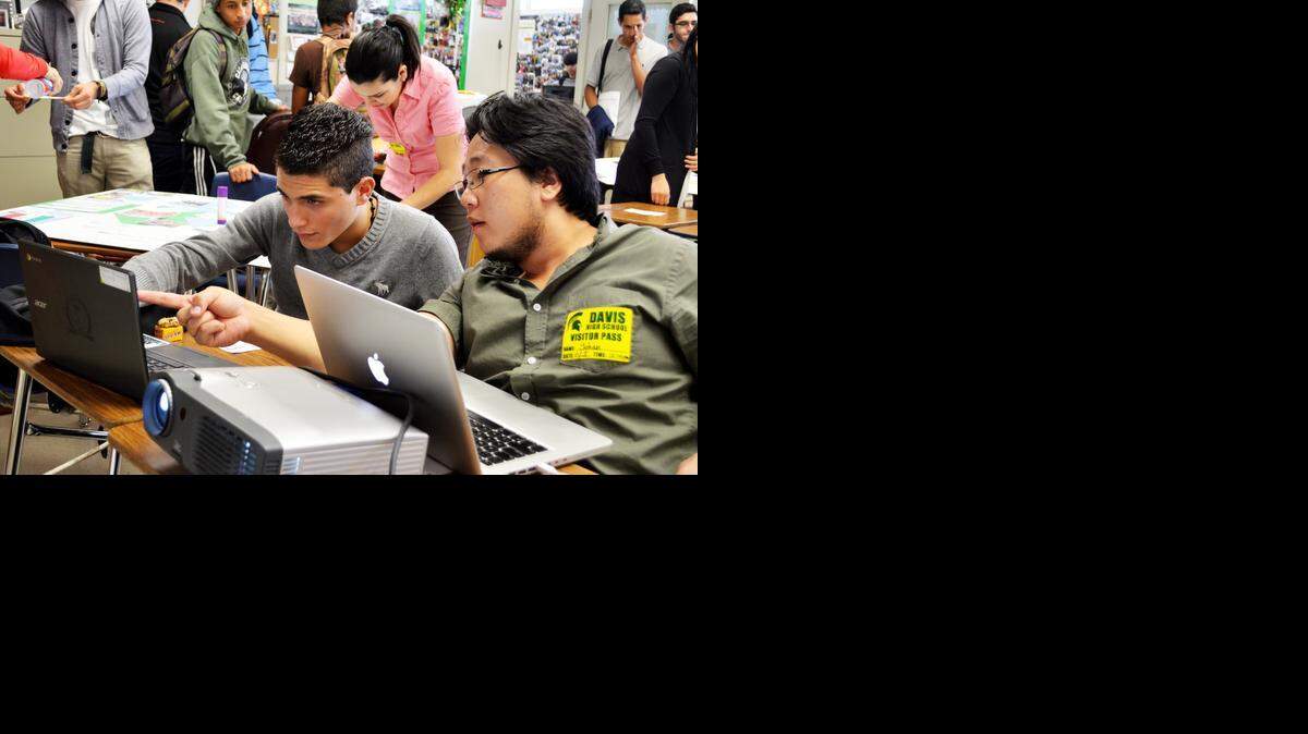 
Student teacher Yohan Partan, right, works with Anees Alkarazoon of Palestine at the Davis High Language Institute in Modesto on Wednesday.
