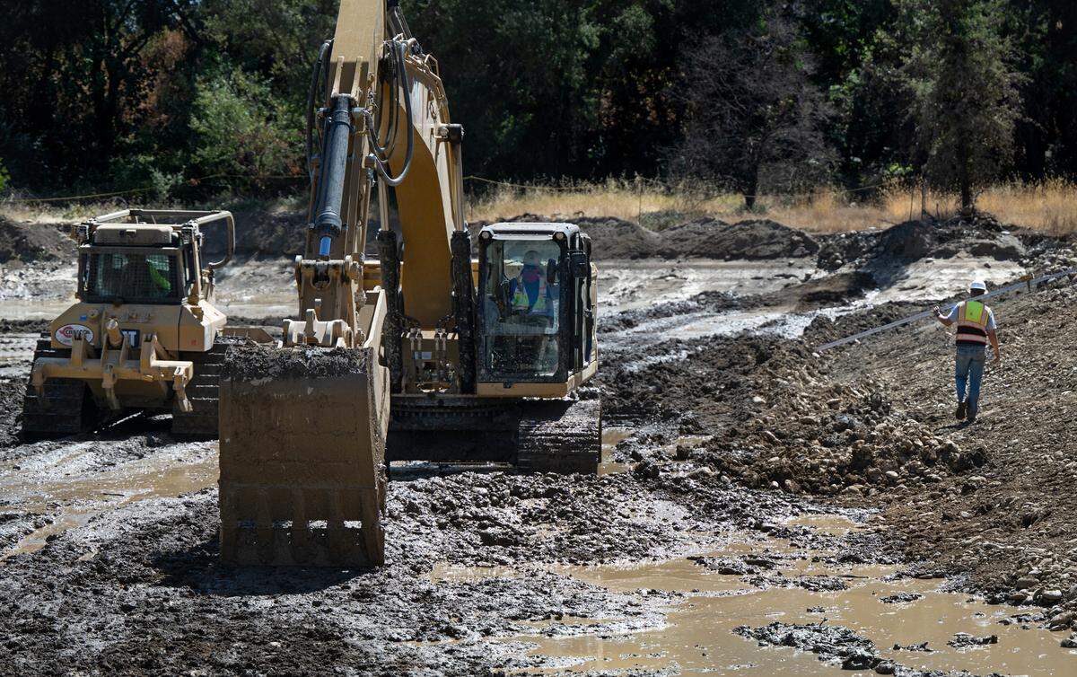 A crew works on grading the floodplain as part of the Basso/La Grange floodplain and spawning habitat restoration project along the Tuolumne River in La Grange, Calif., Thursday, Sept. 12, 2024.