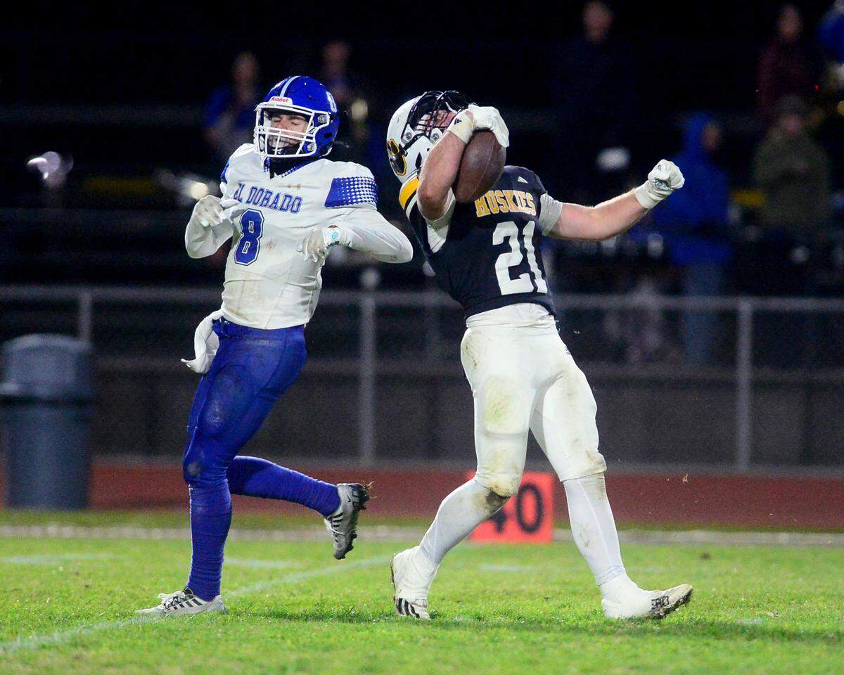 Hughson running back Eli Wilbanks (21) celebrates after a long run during a 2024 CIF Sac-Joaquin Section Division V Playoff game between Hughson High School and El Dorado High School at Hughson High School in Hughson California on November 15, 2024. Hughson won the game 28-6.