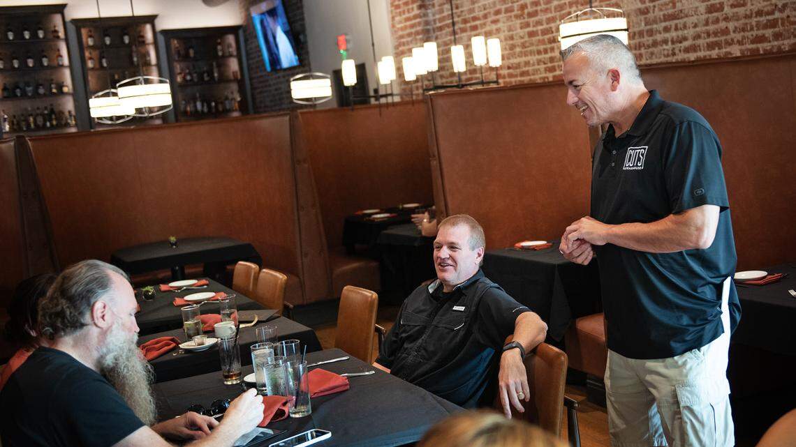 Cuts Steakhouse owner Jerry Powell talks with customers during lunch in Turlock, Calif., on Friday, Aug. 13, 2021. 