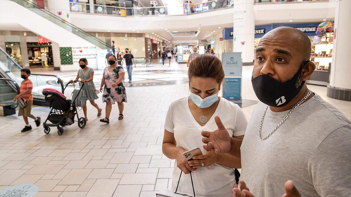 Faisal Khan and his wife Houda Nharat continue to wear masks at Vintage Faire Mall in Modesto, Calif., on Tuesday, June 15, 2021.