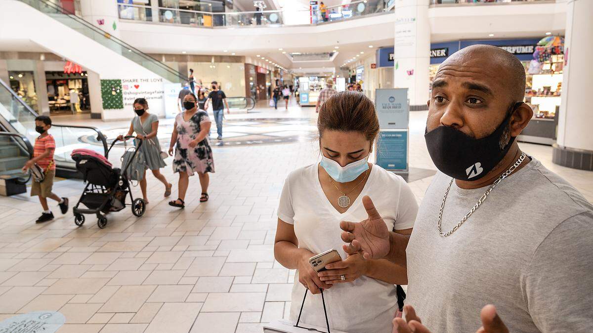 Faisal Khan and his wife, Houda Nharat, wear masks at Vintage Faire Mall in Modesto, Calif., on Tuesday, June 15, 2021.