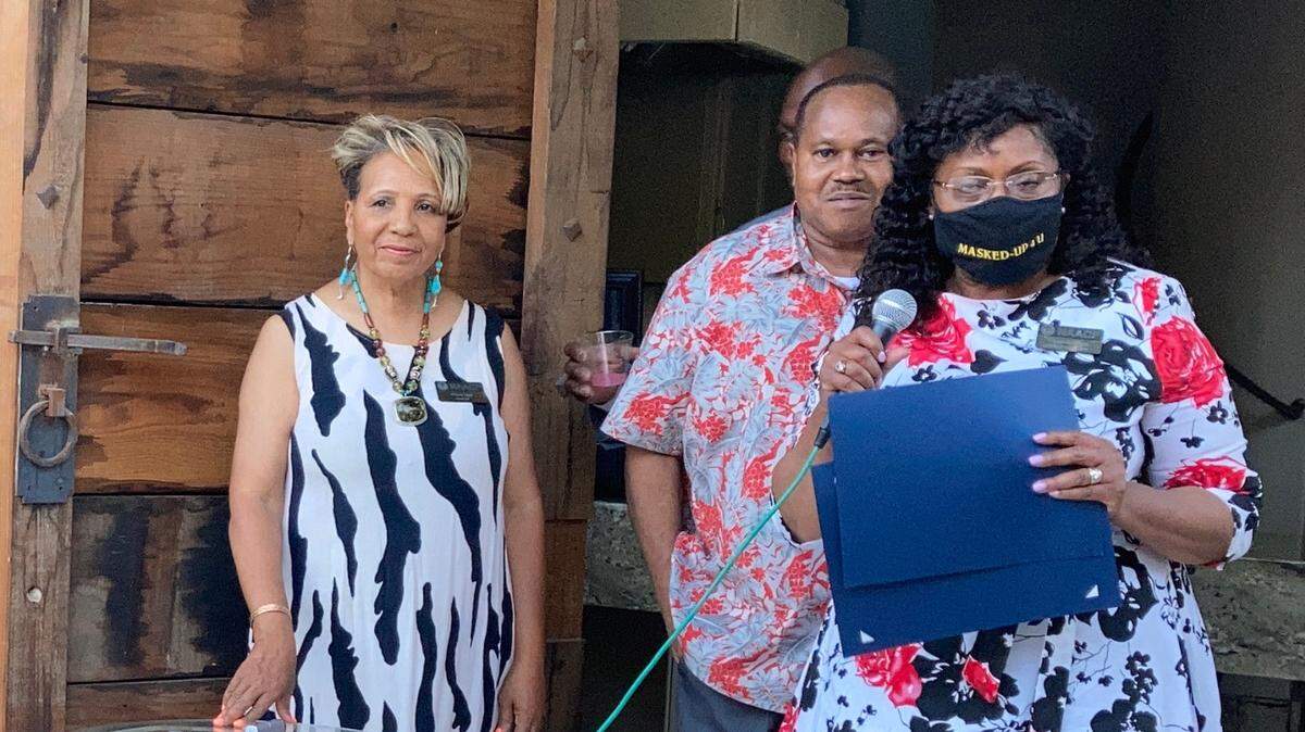Wendy Byrd, president of Modesto/Stanislaus chapter of the NAACP, and Terry Johnson, NAACP labor committee chairperson, present award certificate to honoree, Margaret James, for her 19 years of public services as business analyst for City of Modesto. Modesto, Calif. May 13, 2021