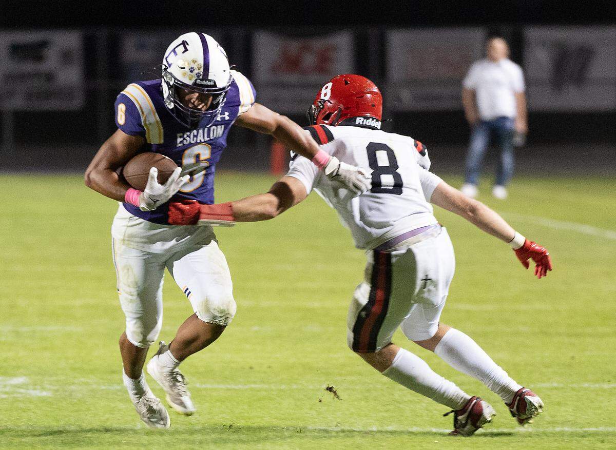 Escalon’s Dominic Arauza breaks a tackle after making a catch during a non-league game against Woodland Christian at Escalon High School on Thursday, Oct. 10, 2024.