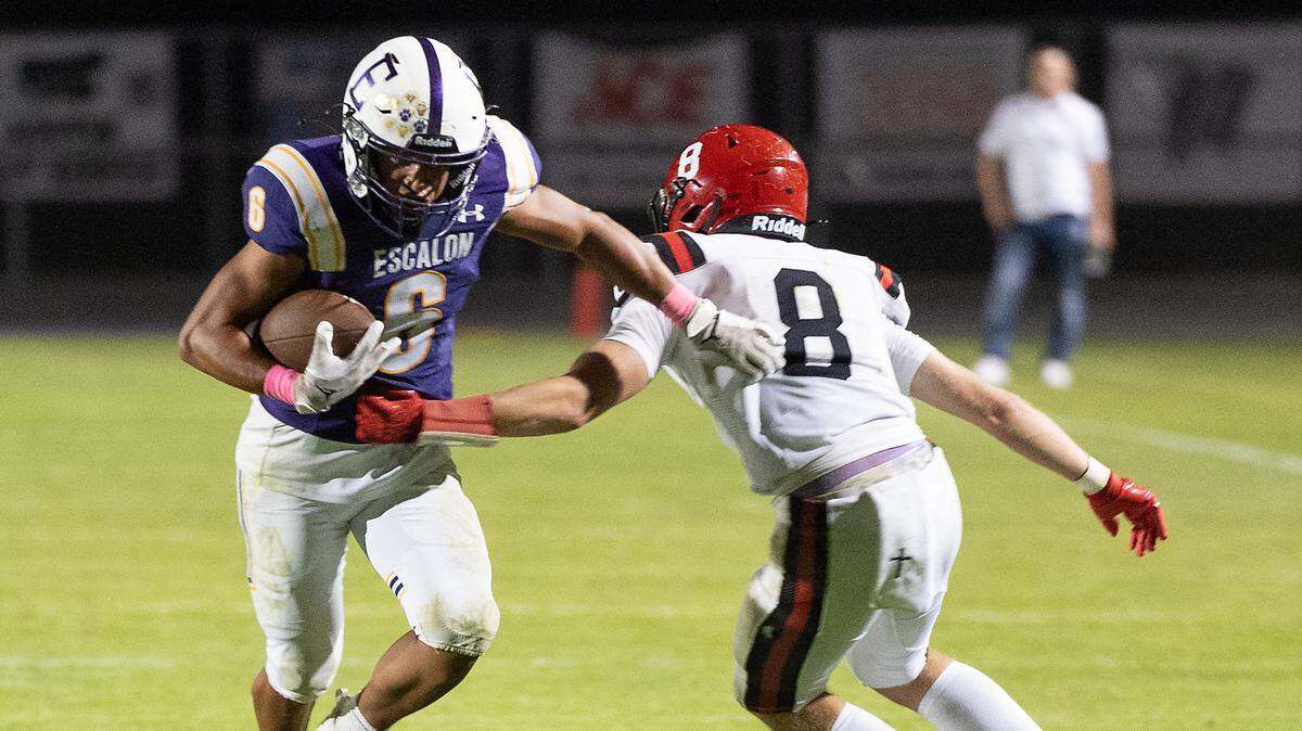 Escalon’s Dominic Arauza breaks a tackle after making a catch during a non-league game against Woodland Christian at Escalon High School on Thursday, Oct. 10, 2024.
