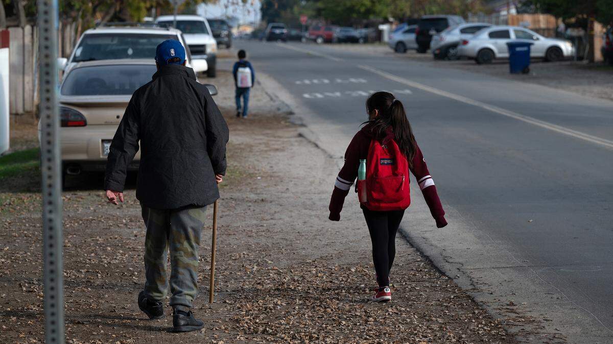 Students walk home from Bret Harte Elementary School along Glenn Avenue in Modesto, Calif., Thursday, Dec. 8, 2022.