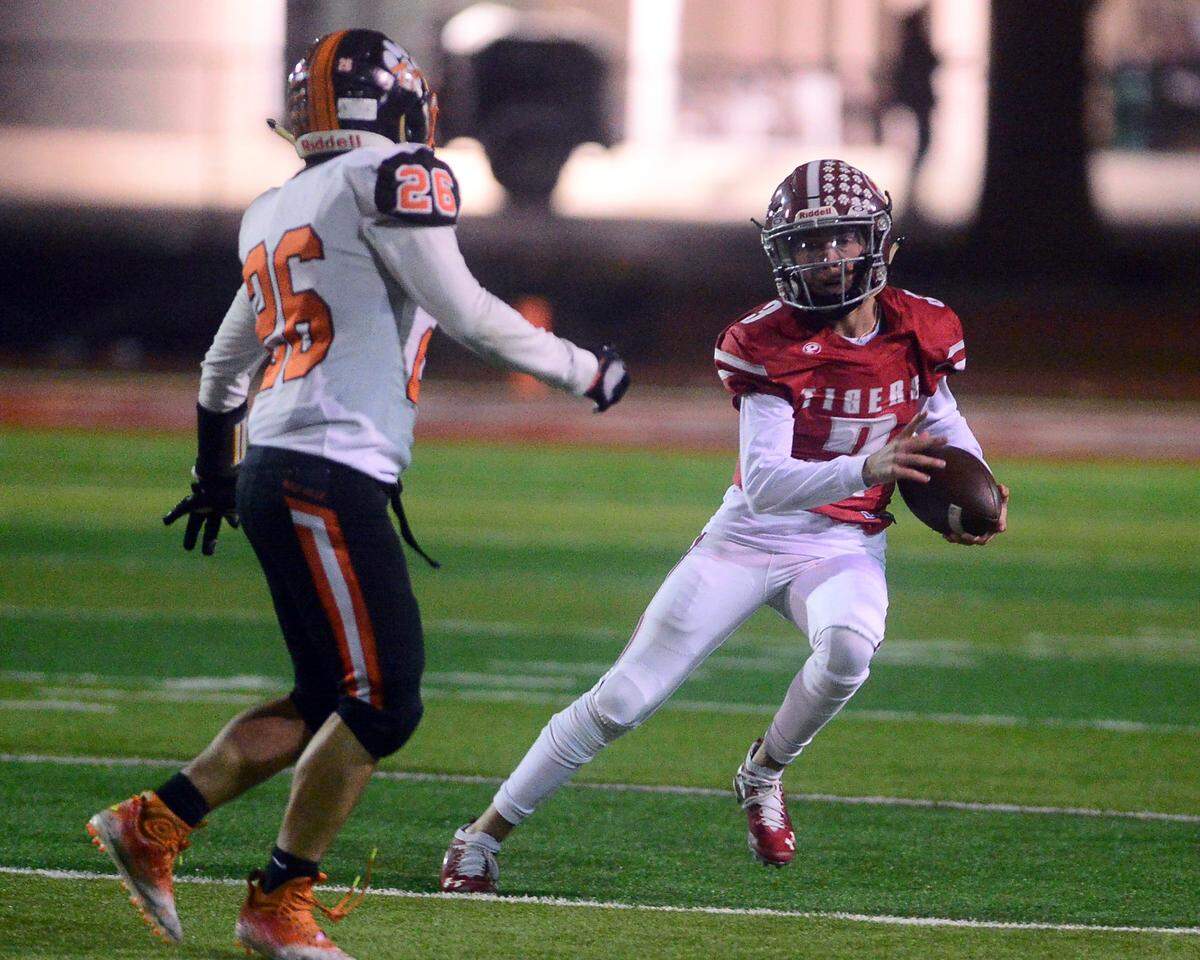 Patterson quarterback Max Medina scrambles during a CIF Division III Sac-Joaquin Section football playoff game against Roseville at Patterson High School in Patterson, California, on Nov. 11, 2022. Patterson won 56-34.