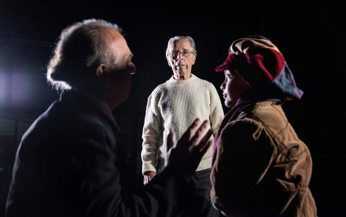 Director Paul Tischer, middle, sets up performers for an editorial photo shoot in preparation for Modesto Performing Arts’ production of “A Christmas Carol” in 2021.