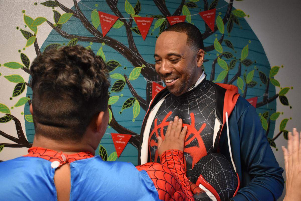 Yuri Williams of Long Beach shares a moment with fellow Spider-Man Juan Garcia, 16, during a giveaway of clothes, backpacks and school supplies on Sunday, Aug. 11, 2019, at Haven Youth Center on H Street in downtown Modesto.