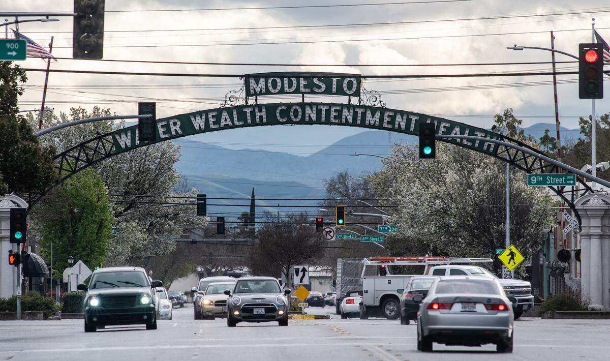 Looking west at the Modesto arch from I Street on a rainy day in downtown Modesto, Calif., on Wednesday, March 10, 2021.