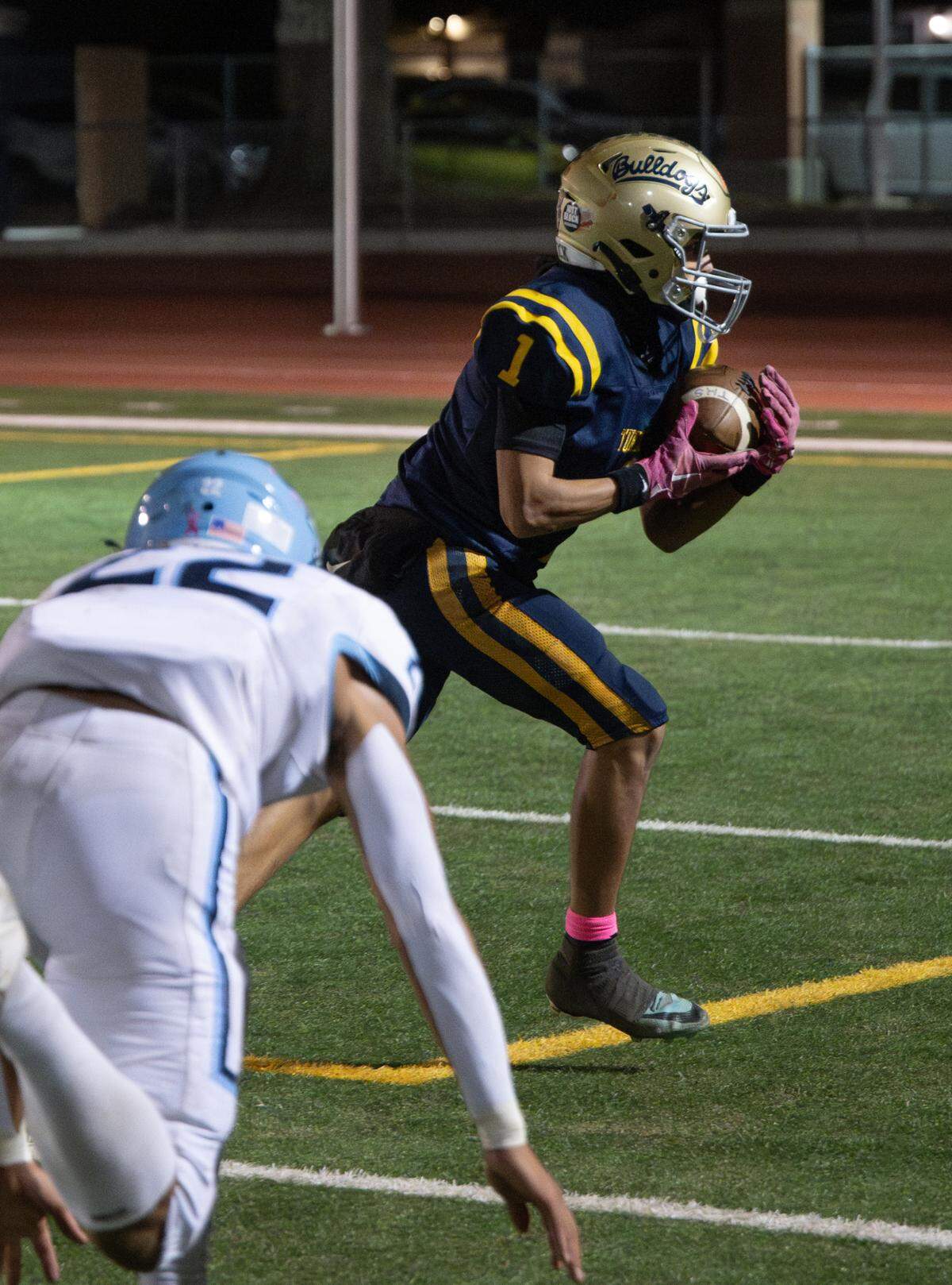 Turlock’s Jr. Silva makes a catch and runs the ball in for a touchdown during the Central California Athletic League game with Downey at Turlock High School in Turlock, Friday, Oct. 18, 2024.